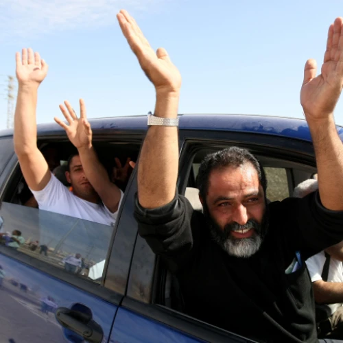 Palestinian terrorists released from Israeli jails, as part of the swap between Israel and Hamas for captive Gilad Shalit, wave as they leave a military base outside Jerusalem, Oct 18, 2011. Photo by Kobi Gideon/Flash90.