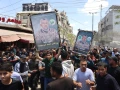 Mourners carry portraits of Ezzedine al-Haddad, the slain chief of the Qassam Brigades, the armed wing of the Palestinian terrorist group Hamas, who was killed in an overnight Israeli strike along with his daughter and wife, during their funeral in Gaza City on May 16, 2026. Photo by Omar Al-Qattaa/AFP via Getty Images.