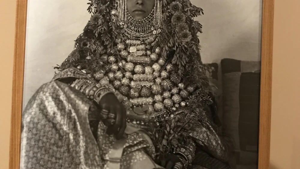 A young Jewish bride in Yemen wearing many pieces of bridal jewelry along with a headpiece. Credit: Shiryn Solny.