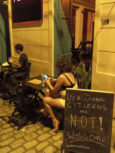 A sign displayed outside a bar in Rio de Janeiro, Brazil, reads: "US & Israel Citizens Are Not Welcome."