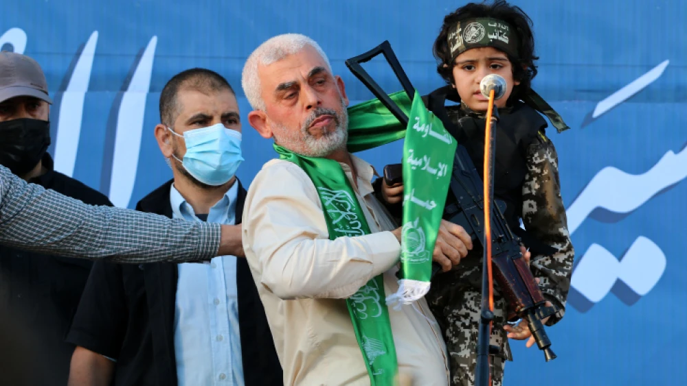 Hamas chief in Gaza Yahya Sinwar holds a boy dressed as a Hamas terrorist during a rally in Gaza City, May 24, 2021. Photo by Atia Mohammed/Flash90.