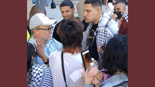 Members of UMass Boston's chapter of Students for Justice in Palestine surround, shove and hurl epithets at CAMERA researcher Dexter Van Zile outside the ADL office in the city. June 24, 2021. Source: X.