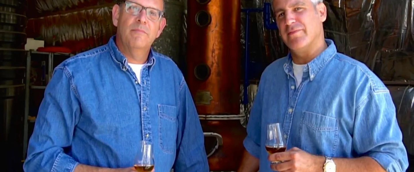 Legends Distillery founders Alan Cohl (left) and Noam Cohen in front of distilling equipment. Credit: Legends Distillery.