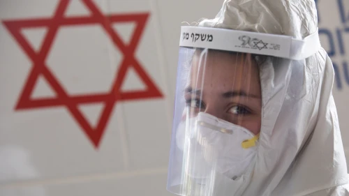 A medical team worker wears protective clothing outside the new coronavirus unit at the Shaare Zedek Medical Center in Jerusalem on April 2, 2020. Photo by Nati Shohat/Flash90.