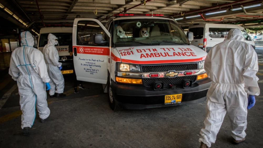 Magen David Adom workers wear protective clothing outside of the coronavirus unit at Shaare Zedek Medical Center in Jerusalem on Sept. 14, 2020. Photo by Nati Shohat/Flash90.