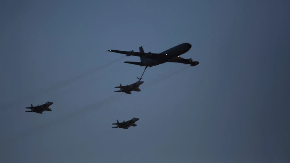 An Israeli KC-135 Stratotanker Boeing 707 plane refuels an F-15 fighter jet as they take part in an air show for a graduation ceremony at the Hatzerim base in the Negev desert, near the southern Israeli city of Beersheva on Dec. 31, 2015. Photo by Lior Mizrahi/Flash90.