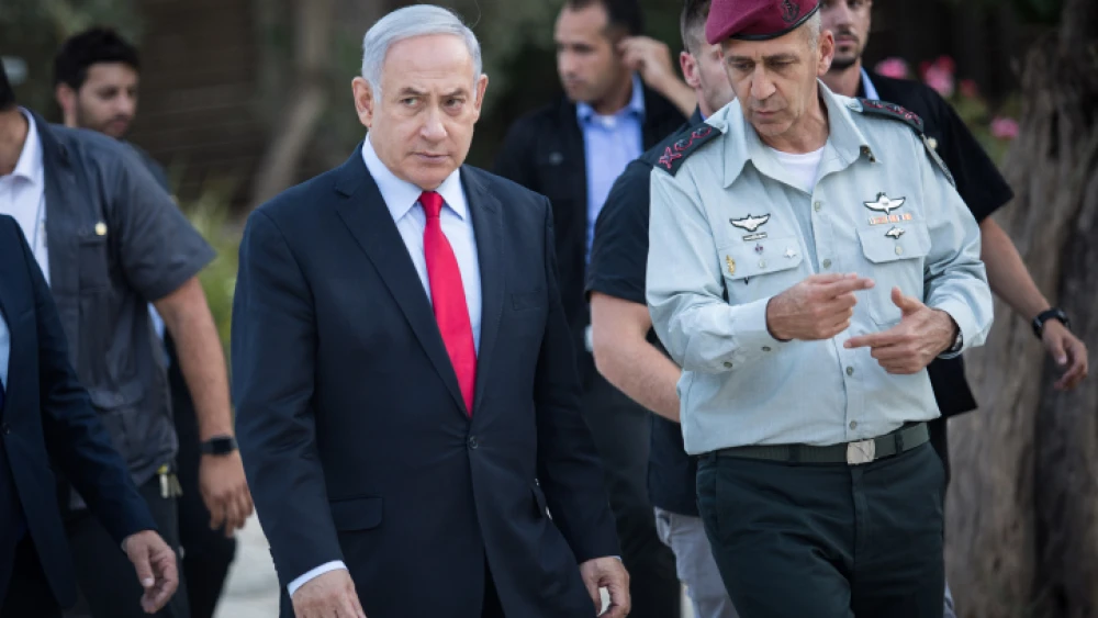 Israeli Prime Minister Benjamin Netanyahu speaks with Israel Defense Forces Chief of Staff Lt. Gen. Aviv Kochavi during an event honoring outstanding IDF reservists at the President's Residence in Jerusalem on July 1, 2019. Photo by Hadas Parush/Flash90.