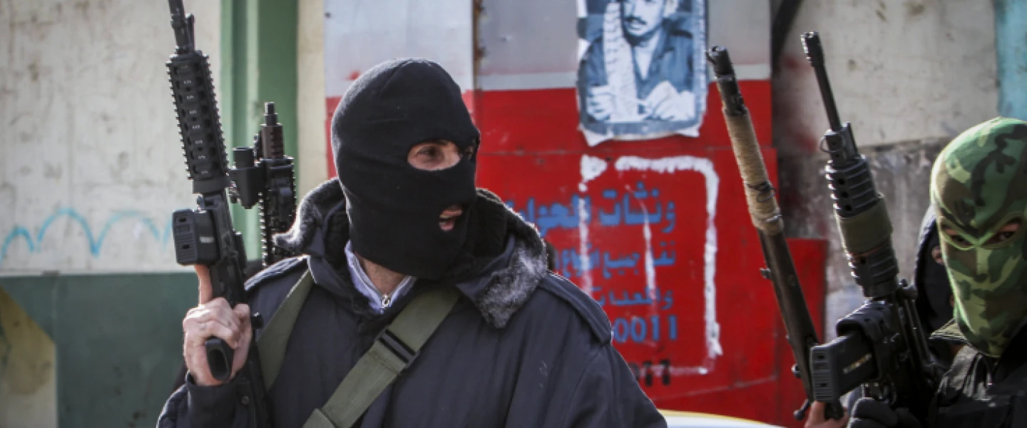 Masked Palestinian militants from the Al-Aqsa Martyrs Brigade, an armed wing linked to Fatah, hold up weapons near Nablus, Jan. 10, 2017. Photo by Nasser Ishtayeh/Flash90.