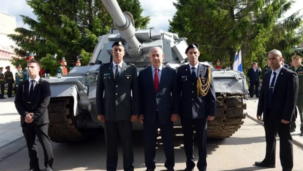 Israeli Prime Minister Benjamin Netanyahu (center) visits an armory museum in the Russian capital of Moscow June 8, 2016. The museum housed an Israeli tank captured by the Syrian army during the First Lebanon War's battle of Sultan Yacoub, but following a request by Netanyahu, Russian President Vladimir Putin agreed to return the tank to Israel. Credit: Haim Zach/GPO.
