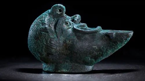 A rare bronze oil lamp, shaped like a grotesque face cut in half, was recently discovered during excavations in Jerusalem’s City of David National Park. May 5, 2021. Credit: Israel Antiquities Authority.