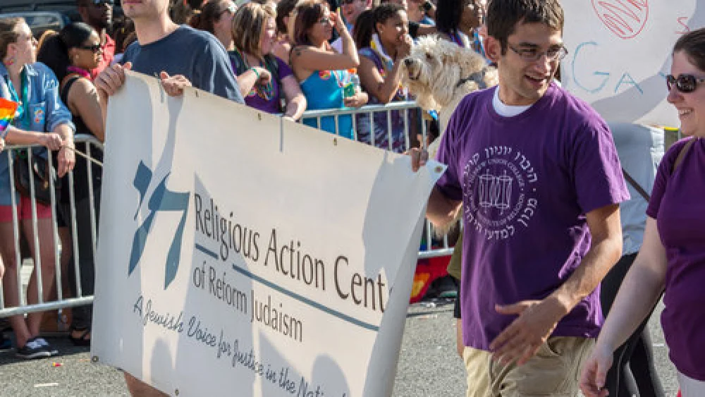 Representatives of the Religious Action Center of Reform Judaism march in a June 2014 gay pride parade in Washington, D.C. Credit: Tim Evanson via Wikimedia Commons.