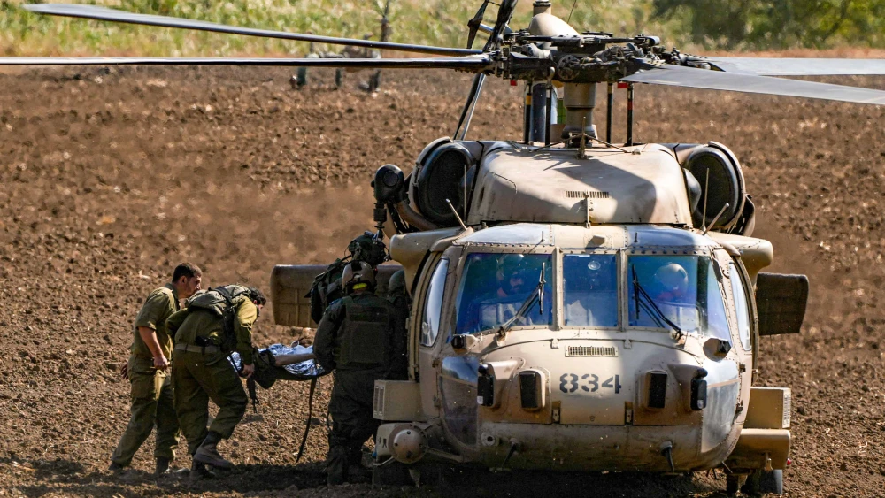Israeli soldiers evacuate an individual wounded by a missile from Lebanon, near the Israel-Lebanon border, Oct. 22, 2024. Photo by Ayal Margolin/Flash90.