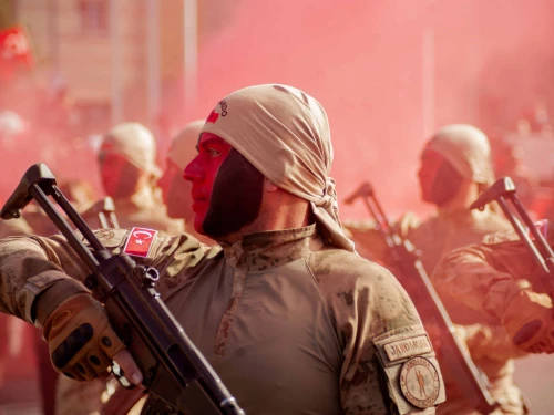 Turkish soldiers stand at attention as red smoke fills the air during Republic Day celebrations in Kayseri on Oct. 29, 2024. Photo by Damoun Pournemati/Middle East Images/AFP via Getty Images.