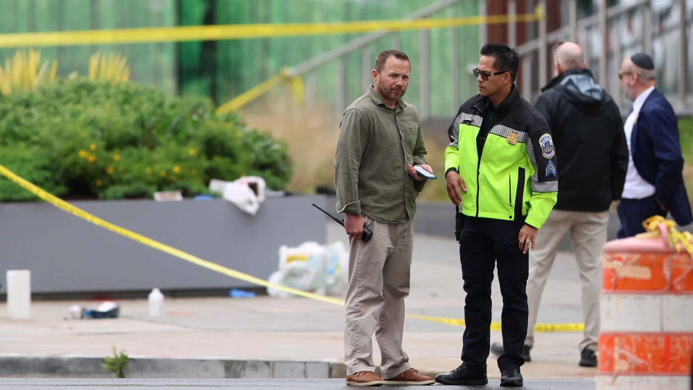Law enforcement officers stand by near the shooting site outside the Lillian and Albert Small Capital Jewish Museum on May 22, 2025 in Washington, D.C. Two Israeli Embassy staff members, Yaron Lischinsky and Sarah Lynn Milgrim, were gunned down Wednesday evening after an event at the museum by a man shouting slogans in support for Palestine. Photo by Tasos Katopodis/Getty Images.