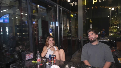 Noam Swissa (left) and Asif Korliker sit outside their hotel in Tel Aviv on Sept. 7, 2024. Photo by Canaan Lidor.