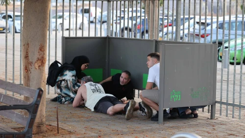 Israelis in Holon take cover as sirens warn of incoming missile fire from Lebanon, Oct. 14, 2024. Photo by Yossi Aloni/Flash90.