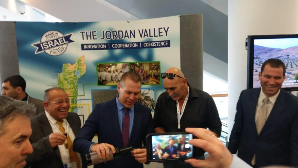 Minister of Strategic Affairs pours wine from Judea and Samaria at Israel Kongress in Frankfurt, together with the head of the Jordan Valley Regional Council David Elhayani and Palestinian human-rights activist Baseem Eid. Credit: Jordan Valley Regional Council.