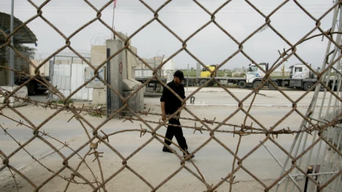A member of the Hamas security forces stand guard at the Kerem Shalom crossing between Israel and the southern Gaza Strip on Feb. 24, 2014. Photo Abed Rahim Khatib/Flash90.