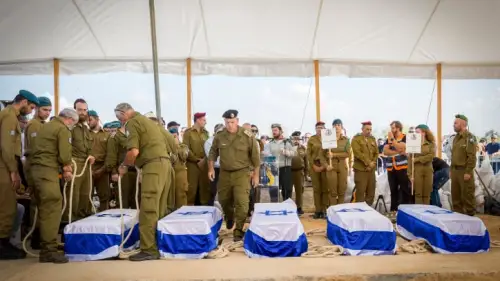 Mourners attend the funeral of five members of the Kotz family, murdered by terrorists on Oct. 7 in Kfar Aza, on Oct. 17, 2023. Photo by Flash90.