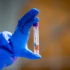 A health care worker holds a swab sample at a COVID-19 drive-through testing facility in Modi'in, Feb. 1, 2022. Photo by Yossi Aloni/Flash90.