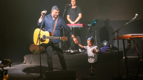 Ishay Ribo welcomes an ADI special education student with severe disabilities to the Jerusalem Theater stage at the ADI Jerusalem benefit concert on Monday evening, June 6.