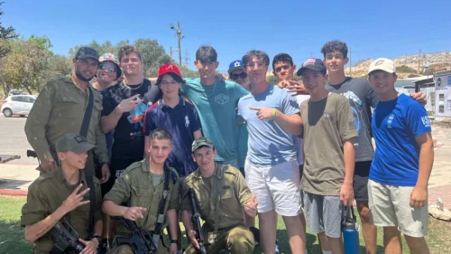 Participants in the Jewish National Fund-USA teen volunteer in Israel mission pose with Israel Defense Forces soldiers in the Negev. Credit: Courtesy.