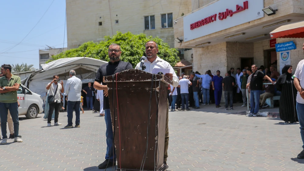 Hamas spokesman Hazem Qassem (left) and Ismail Thawabta, head of Hamas's "government" media office, speak at a press conference outside Al-Aqsa Martyrs Hospital in Deir al-Balah, the central Gaza Strip, July 6, 2026. Photo by Ahmad Hasaballah/Getty Images.