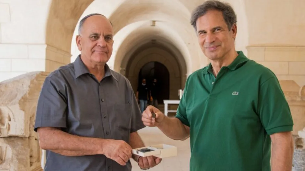 IAA Director Eli Eskosido, left, presents Israeli astronaut Eytan Stibbe with a coin dating to the era of the Bar Kochba Revolt. Photo by Yoli Schwartz/IAA.