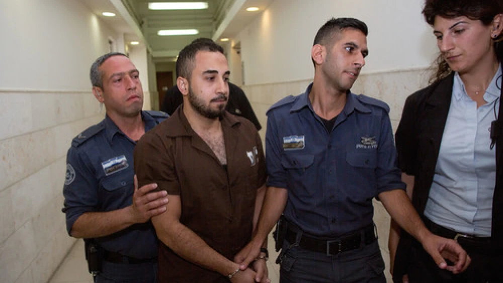 Click photo to download. Caption: Khalil Adel Khalil (second from left), 25, of the A-Tur neighborhood in Jerusalem, is brought to Jerusalem's District Court on July 9, 2015. Khalil, who admitted to trying to join the Islamic State terror group in Syria, was sentenced to two years in prison. Credit: Yonatan Sindel/Flash90.