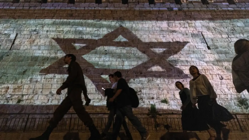 The Israeli flag is projected on the walls of Jerusalem's Old City, Nov. 7, 2023. Photo by Chaim Goldberg/Flash90.