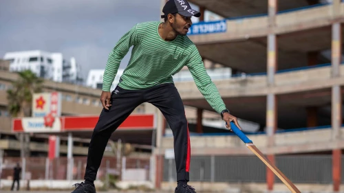 A foreign worker from India plays cricket in an empty parking lot in south Tel Aviv, April 27, 2024. Photo by Dor Pazuelo/Flash90.