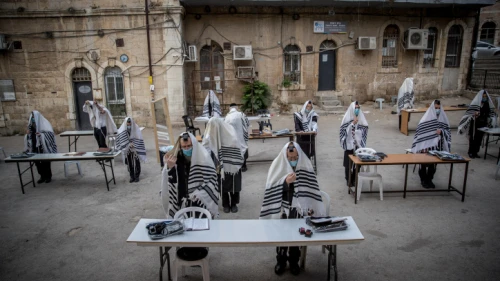 Chassidic Jews praying in accordance with social-distancing rules outside of their synagogue in Jerusalem on Aug. 10, 2020. Photo by Yonatan Sindel/Flash90.