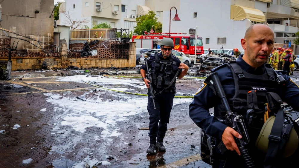 Israeli security and rescue forces at the scene where a rocket fired from the Gaza Strip hit buildings and cars in the southern Israeli city of Ashdod, Oct. 9, 2023. Credit: Liron Moldovan/Flash90.