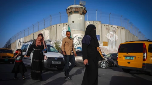 Palestinians make their way through an Israeli checkpoint near Bethlehem to attend Friday prayers at Jerusalem's Al-Aqsa mosque, April 29, 2022. Photo by Wisam Hashlamoun/Flash90.