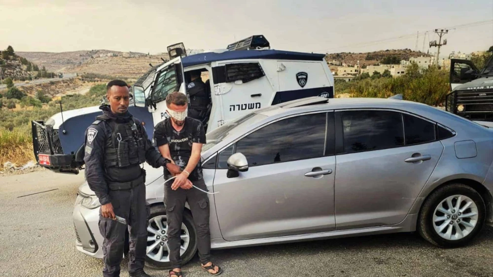 An Israeli police officer detains a Palestinian suspect in an undisclosed location in Judea and Samaria, as part of the law enforcement operation “Stopping at Red,” carried out in August, 2025. Credit: Israel Police.