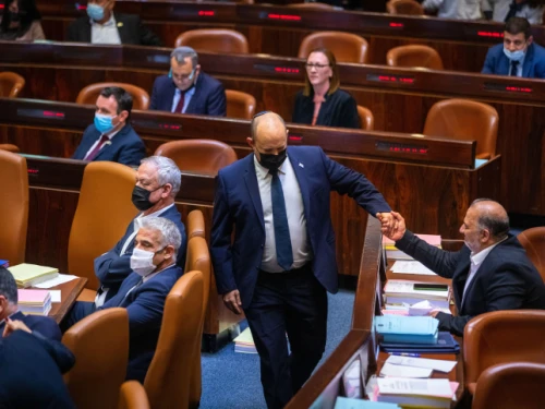 Then-Israeli Prime Minister Naftali Bennett with Ra’am Party head Mansour Abbas during a plenum session and a vote on the state budget at the assembly hall of the Knesset in Jerusalem on Nov. 3, 2021. Photo by Olivier Fitoussi/Flash90.