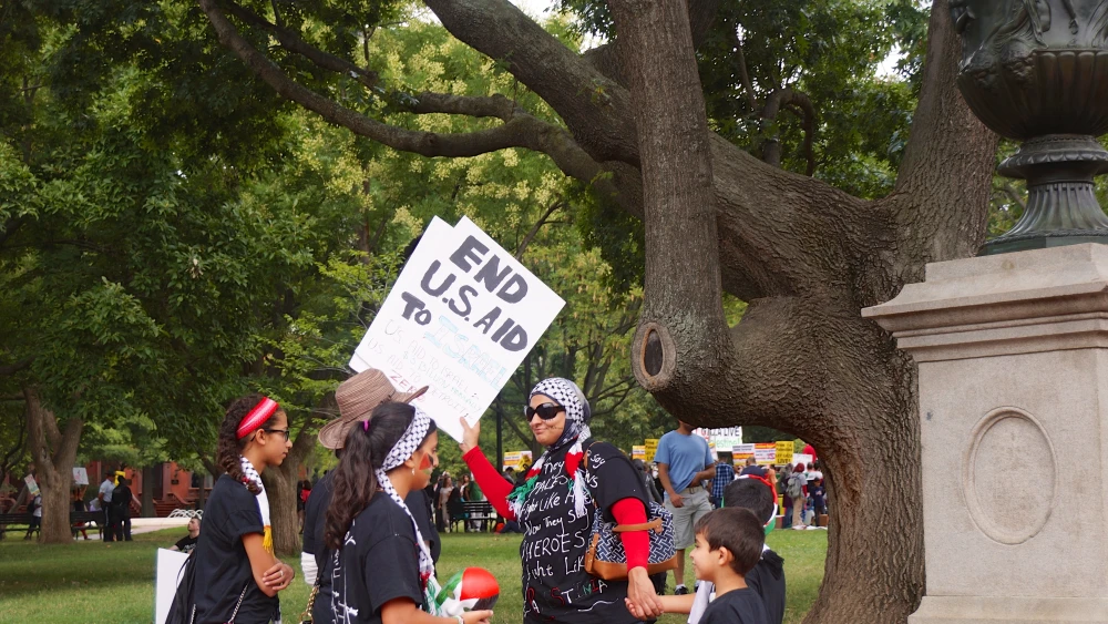 A woman carrying a sign reading, "End U.S. aid to Israel," at an anti-Israel protest in Washington, D.C., Aug. 2, 2014. Credit: Ted Eytan via Creative Commons.