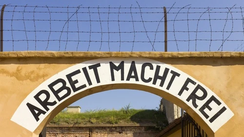 Theresienstadt concentration-camp archway with the phrase Arbeit Macht Frei, meaning "work makes (you) free," that was placed over the entrance in a number of Nazi concentration camps. Israeli Deputy Defense Minister Danny Danon wrote on International Holocaust Remembrance Day for JNS.org. Credit: Godot13 via Wikimedia Commons.