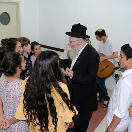 Tzfat Chief Rabbi Shmuel Eliyahu enjoys pre-Shabbat activities at the OneFamily Sleepaway camp in northern Israel in July 2019. Photo by Eytan Morgenstern.