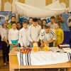 Participants in the Bar/Bat Mitzvah Family Camp reading from a Torah scroll in the Siberian city of Novosibirsk in August 2014. Credit: Roman Ibragimov.