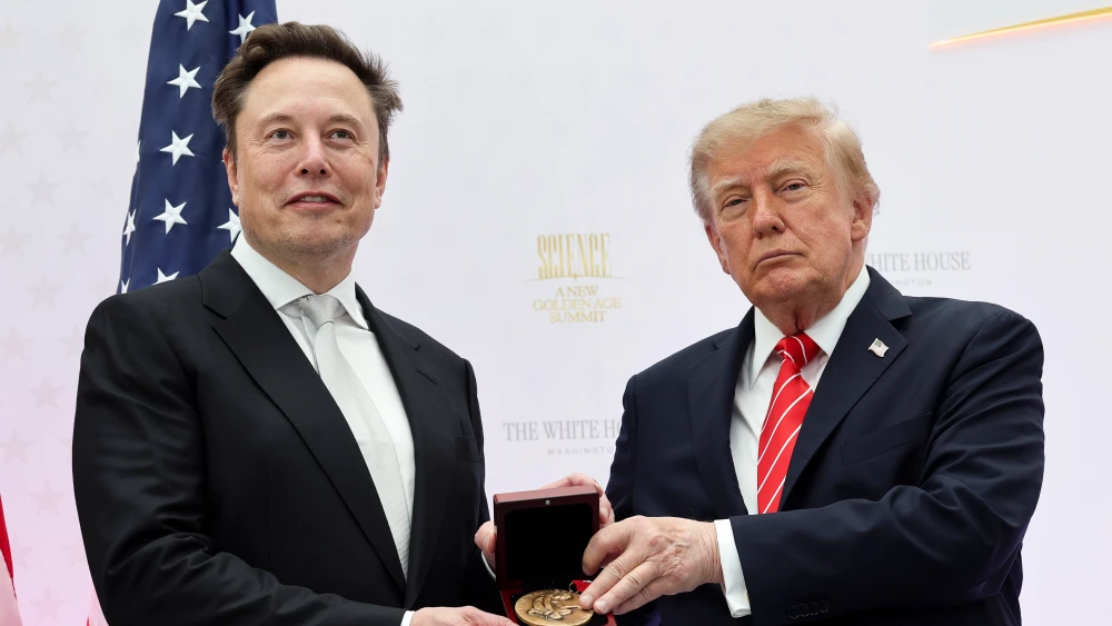 Tesla and SpaceX CEO Elon Musk (L) receives the National Medal of Science from U.S. President Donald Trump during the Golden Age of American Innovation Summit at the Institute of Peace on Oct. 8, 2026 in Washington, DC. Trump awarded some of the nation's highest scientific honors to technology leaders including Elon Musk, Sergey Brin, Jensen Huang, Lisa Su, Michael Dell, and Satya Nadella. Photo by Win McNamee/Getty Images.