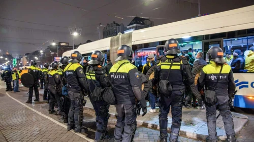 Dutch mobile police officers stand guard after violence broke out in central Amsterdam following the UEFA Europa League soccer match between Ajax Amsterdam and Maccabi Tel Aviv, Nov. 8, 2024. Photo by VLN Niews/ANP/AFP via Getty Images.