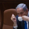 Israeli Prime Minister Benjamin Netanyahu seen drinking coffee during a plenum session in the assembly hall of the Israeli parliament on June 17, 2015. Photo by Miriam Alster/Flash90.