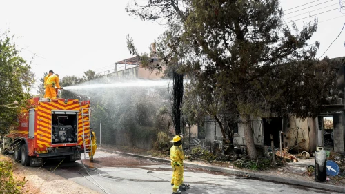 Firefighters extinguish the remains of a fire in in moshav Mevo Modi'im on May 24, 2019. Photo by Avi Dishi/Flash90.