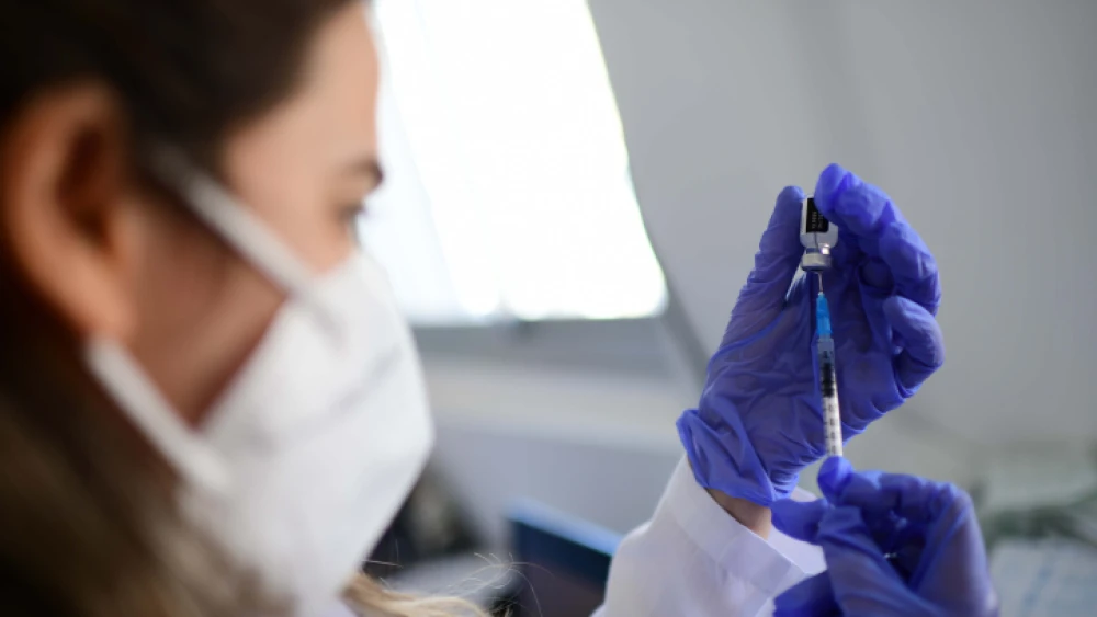 A COVID-19 injection is prepared at a vaccination center in South Tel Aviv, Feb 14, 2021. Photo by Tomer Neuberg/Flash90.