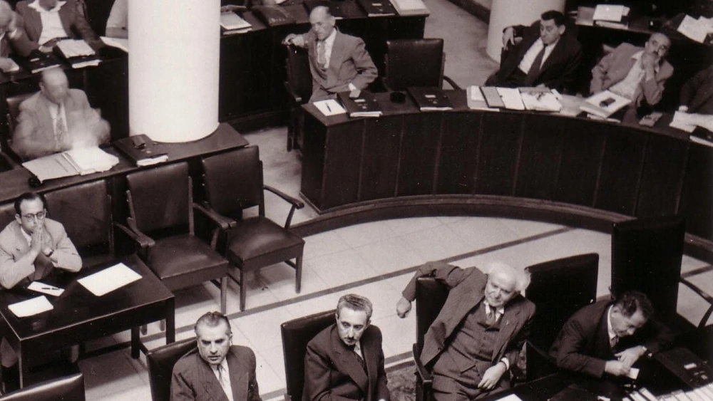 The Knesset plenum at Frumin House in Jerusalem in 1952. From bottom left to right: Haim-Moshe Shapira, Moshe Sharet, David Ben-Gurion and Ze’ev Sherf. Credit: Public Domain via Wikimedia Commons.