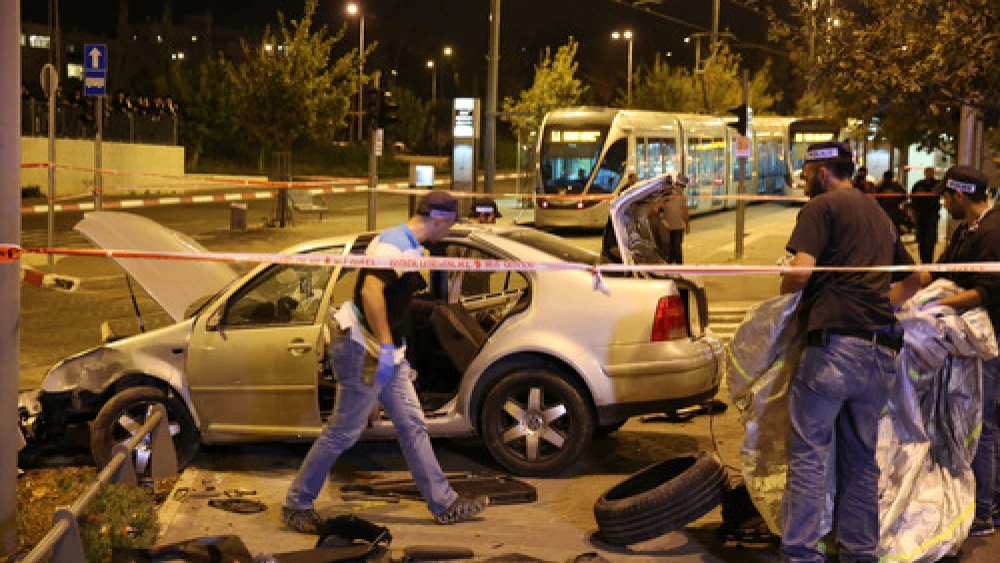 Click photo to download. Caption: Police and resuce personnel at the scene where a car crashed into Jerusalem's Ammunition Hill light rail station in a terror attack on October 22, 2014. Credit: Flash90.