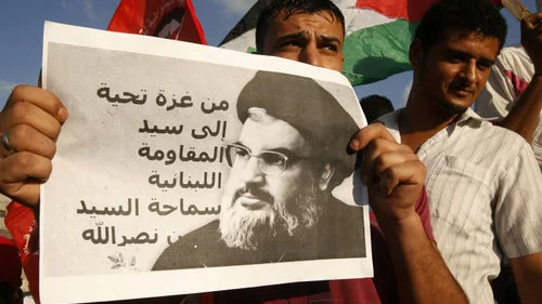 A Palestinian protester from the Popular Front for the Liberation of Palestine (PFLP) holds a picture Hezbollah leader Sheikh Hassan Nasrallah during a demonstration in Rafah, in the southern Gaza Strip, on Sept. 3, 2014. Credit: Abed Rahim Khatib/Flash90.