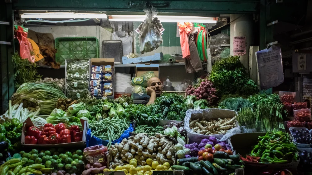 A shop owner takes a phone call at Jerusalem's Mahane Yehuda Market, July 27, 2016. Photo by Zack Wajsgras/Flash90.
