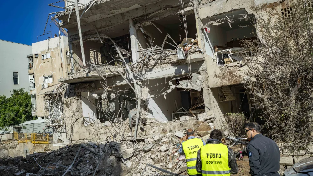 Israeli security and rescue forces at the scene where a missile fired from Iran toward Israel caused damage in Tel Aviv, March 24, 2026. 